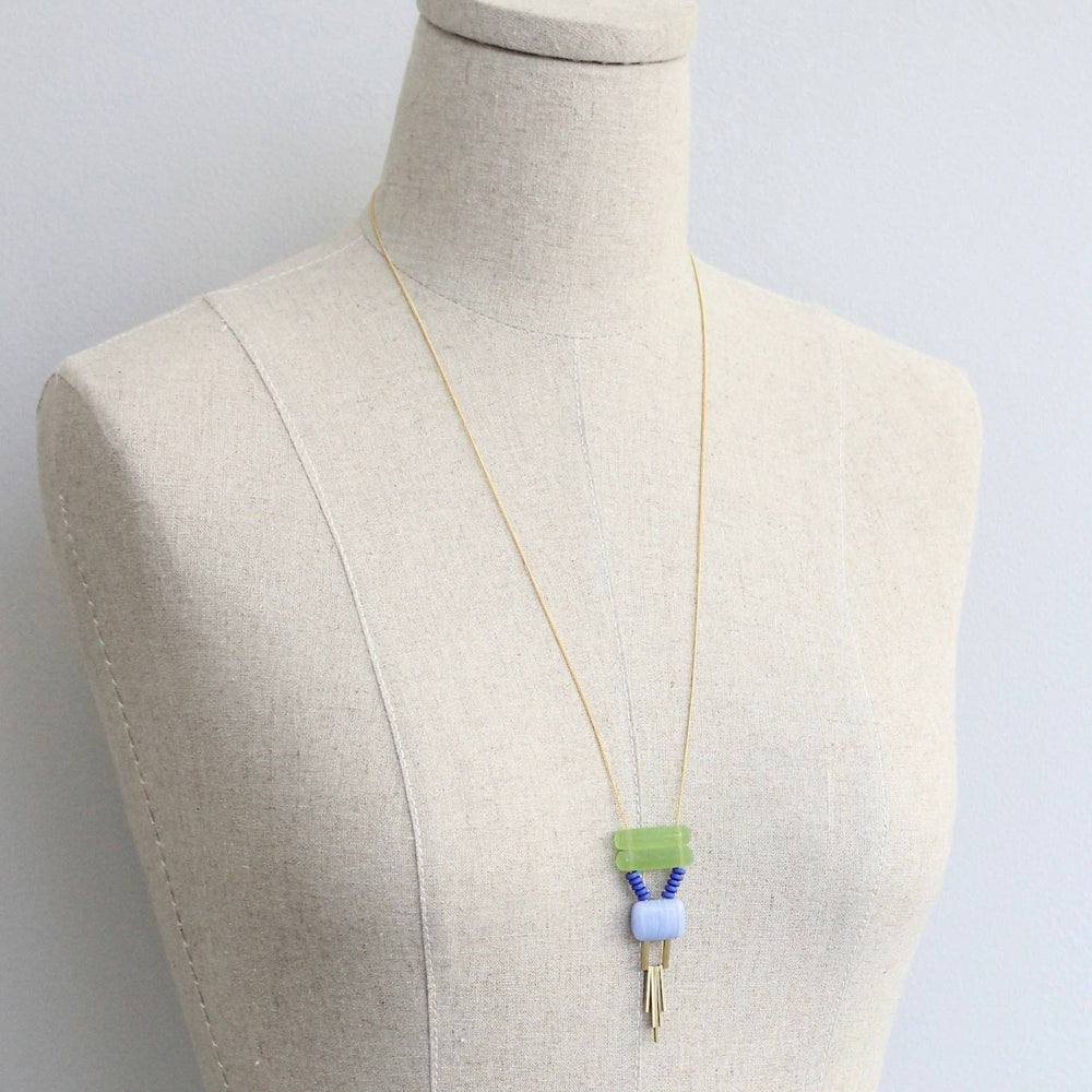 Necklace with a pendant on a mannequin against a light gray background