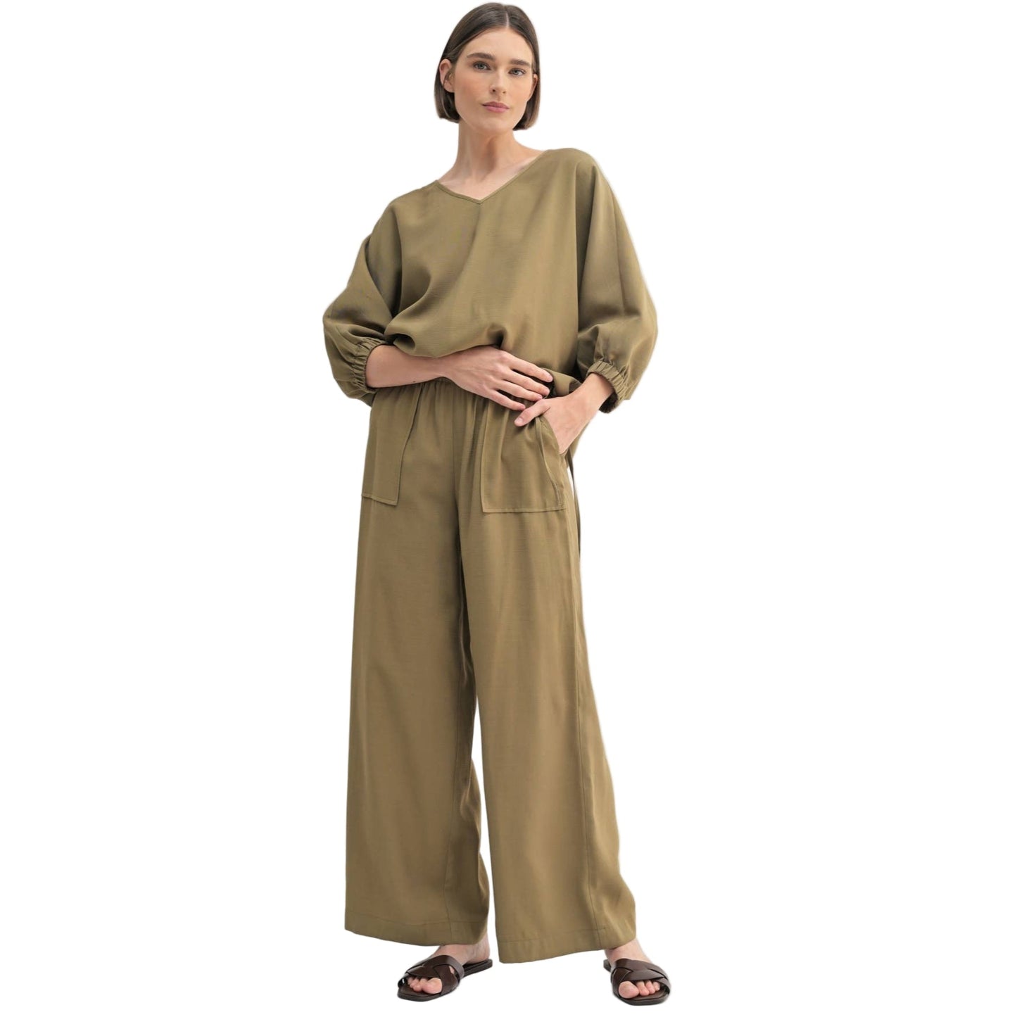 Woman wearing a green pants on a white background