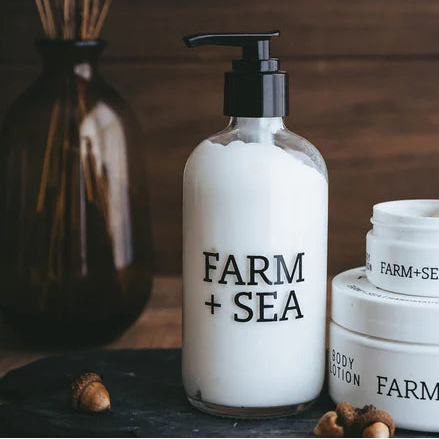Farm + Sea skincare products on a wooden surface with a dark background