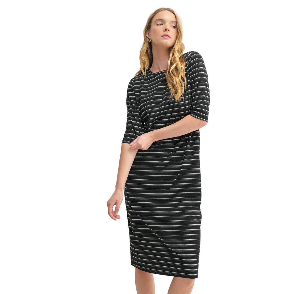 
                      
                        Woman wearing a black and white striped dress on a white background
                      
                    