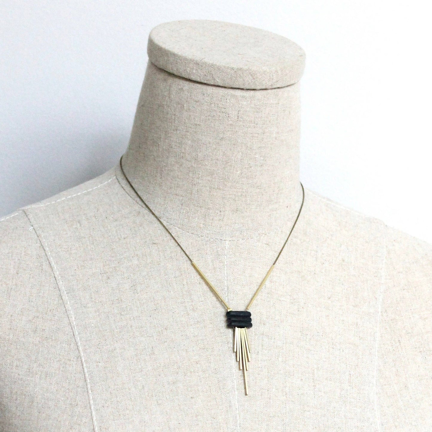 Necklace on a mannequin bust against a white background