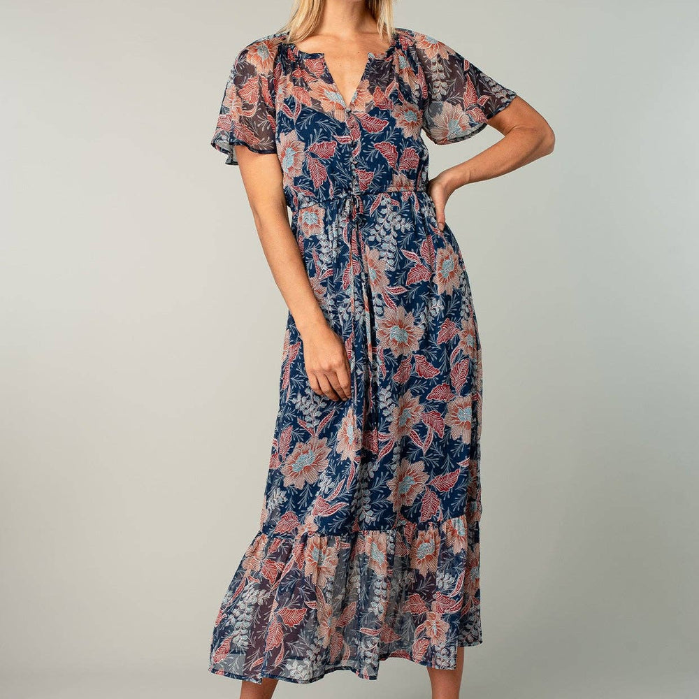 
                      
                        Woman wearing a floral dress on a plain background
                      
                    