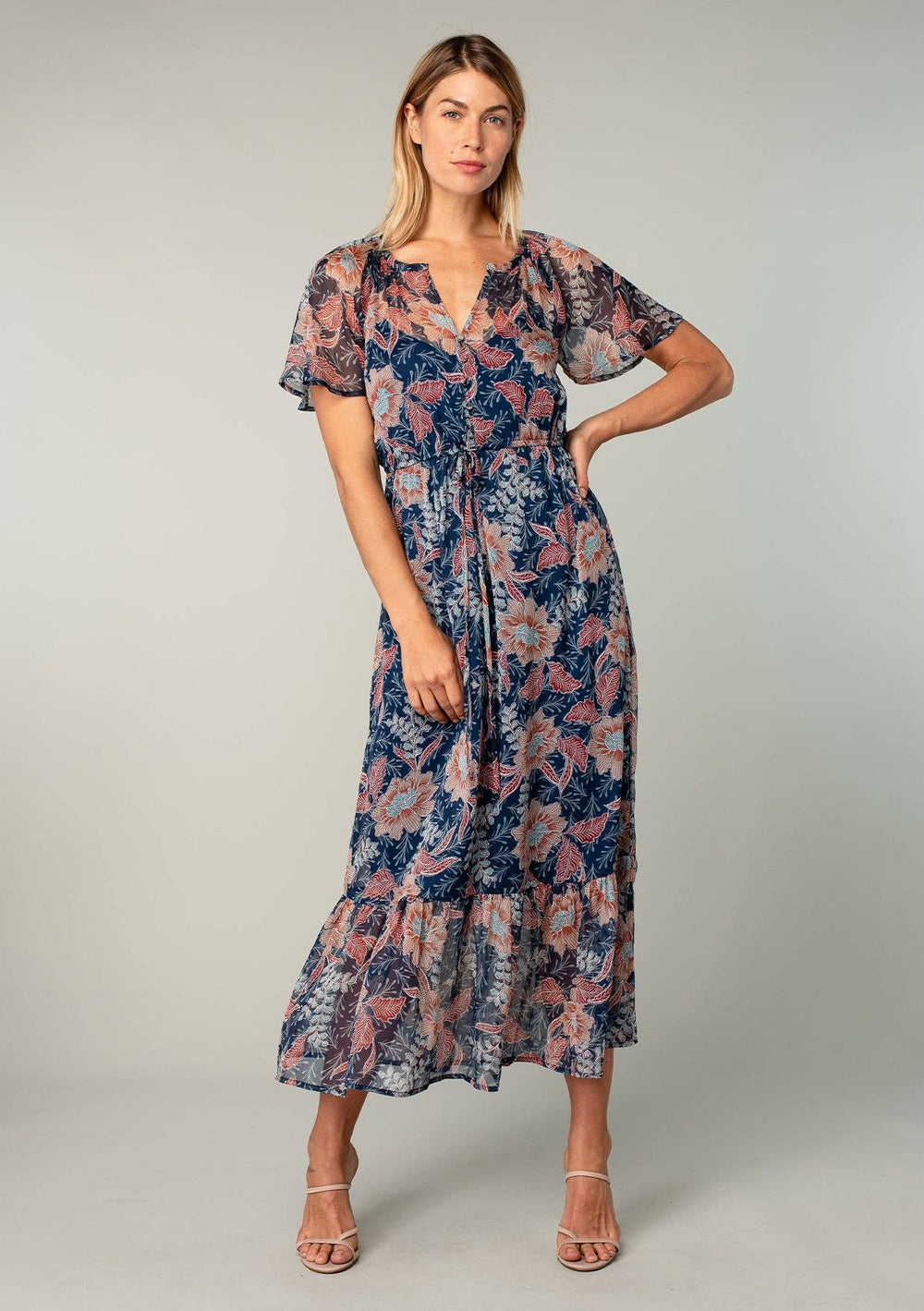 Woman wearing a floral dress on a plain background