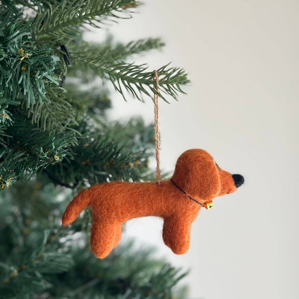 Felted dog ornament hanging on a Christmas tree