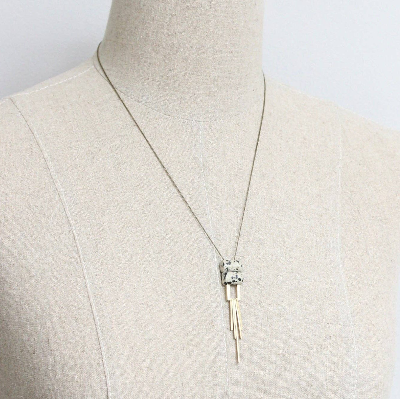 Necklace on a mannequin with a plain background