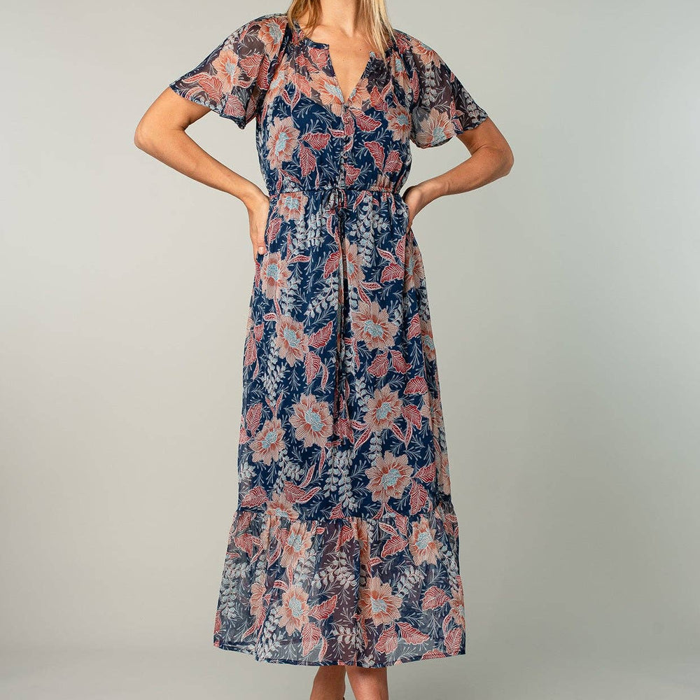 
                      
                        Woman wearing a floral dress on a plain background
                      
                    