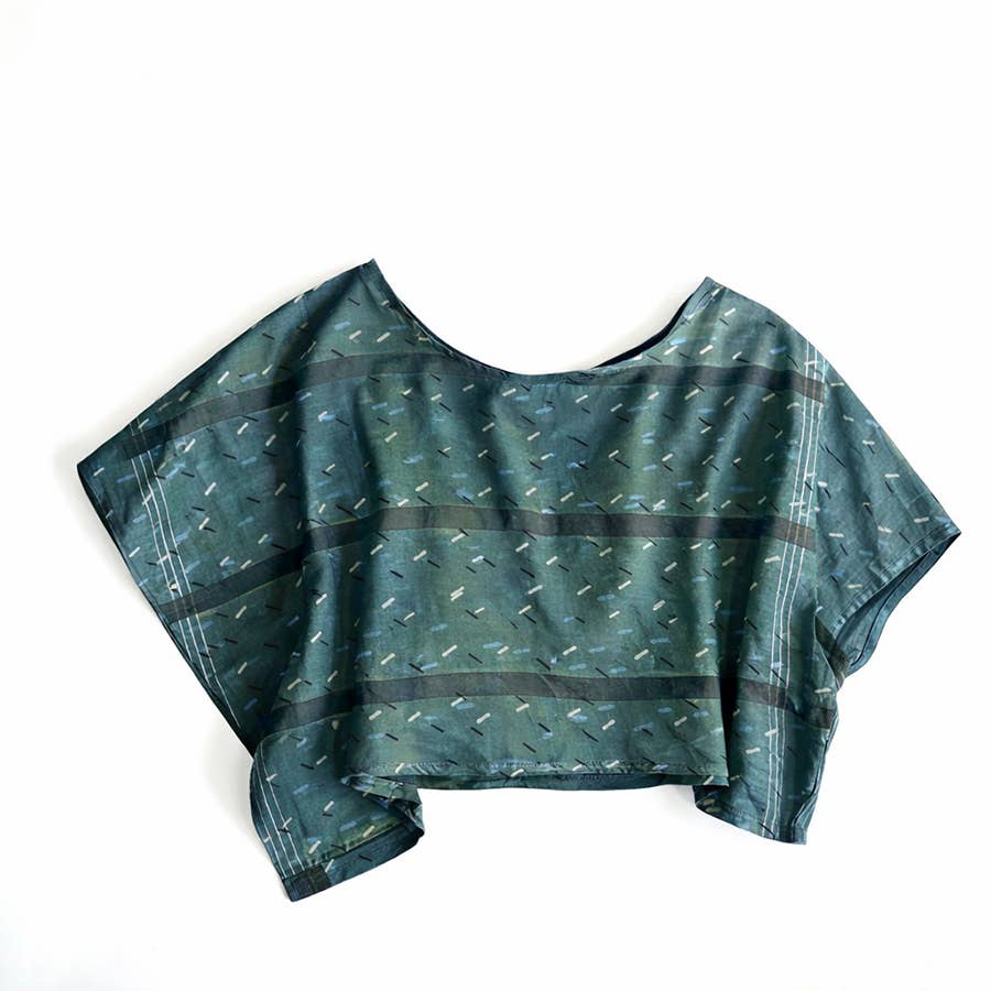 Green patterned crop top on a white background