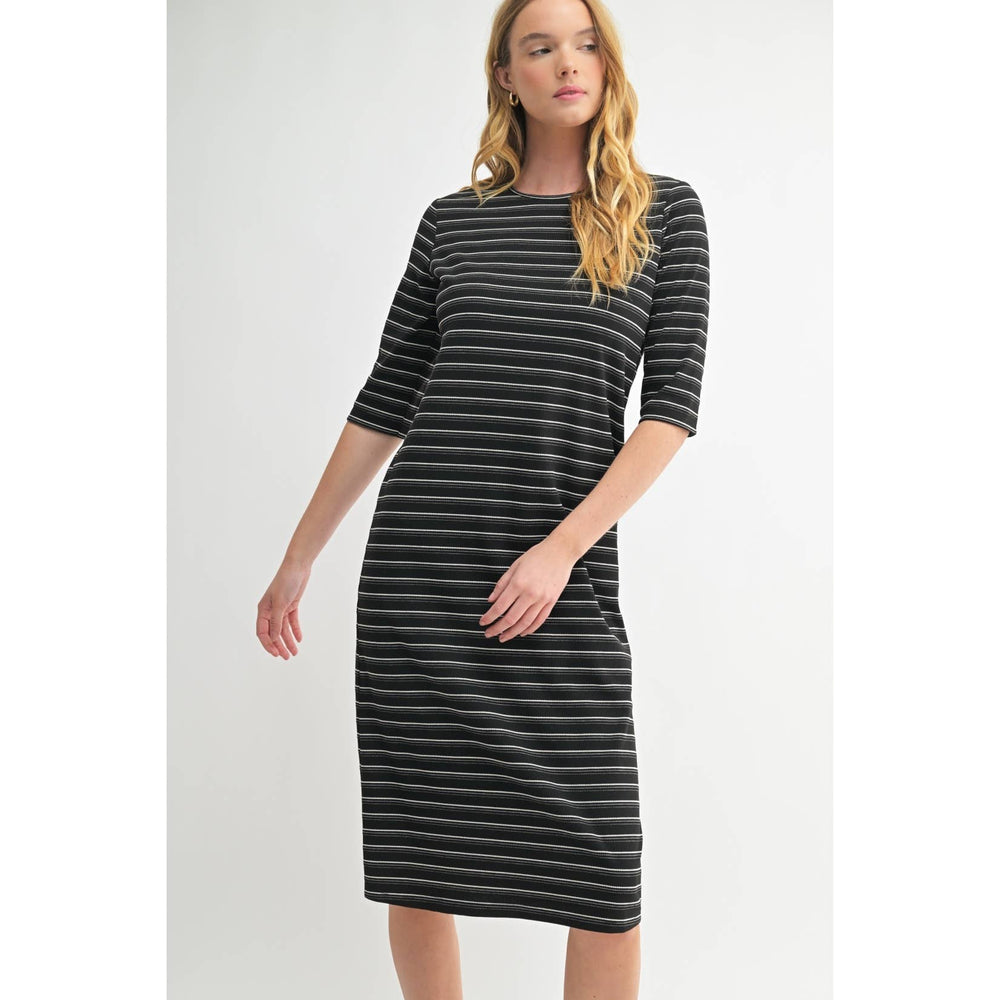 
                      
                        Woman wearing a black and gray striped dress on a white background
                      
                    