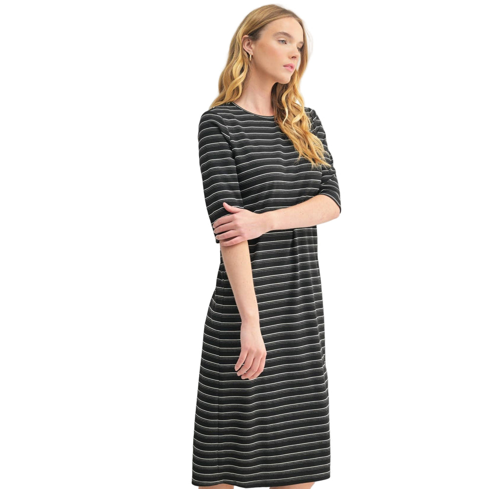 
                      
                        Woman wearing a black and gray striped dress on a white background
                      
                    