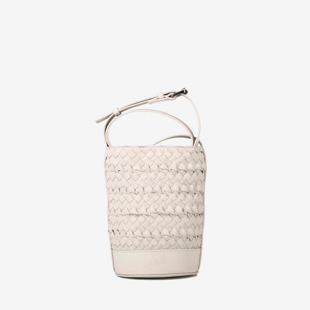 
                      
                        A mini small stone white woven leather bucket bag  with an adjustable crossbody strap - image 5
                      
                    